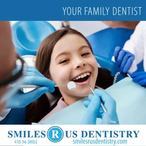 Dentist showing child a model of teeth